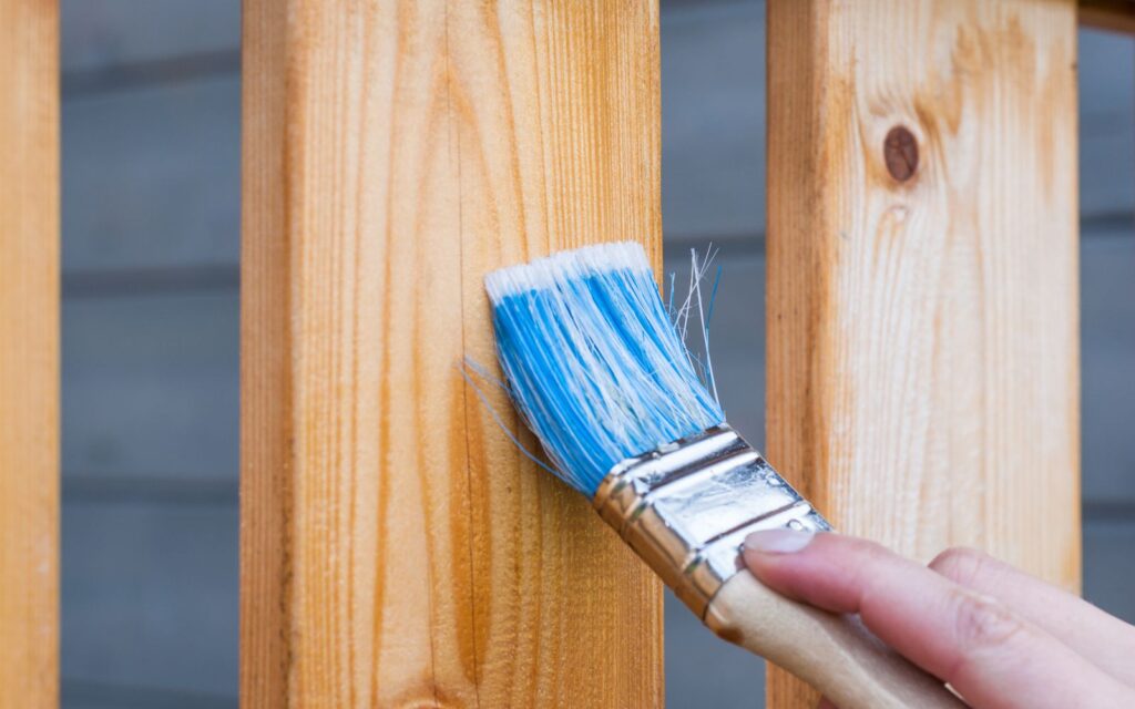 Paintbrush ready to refresh garden woodwork