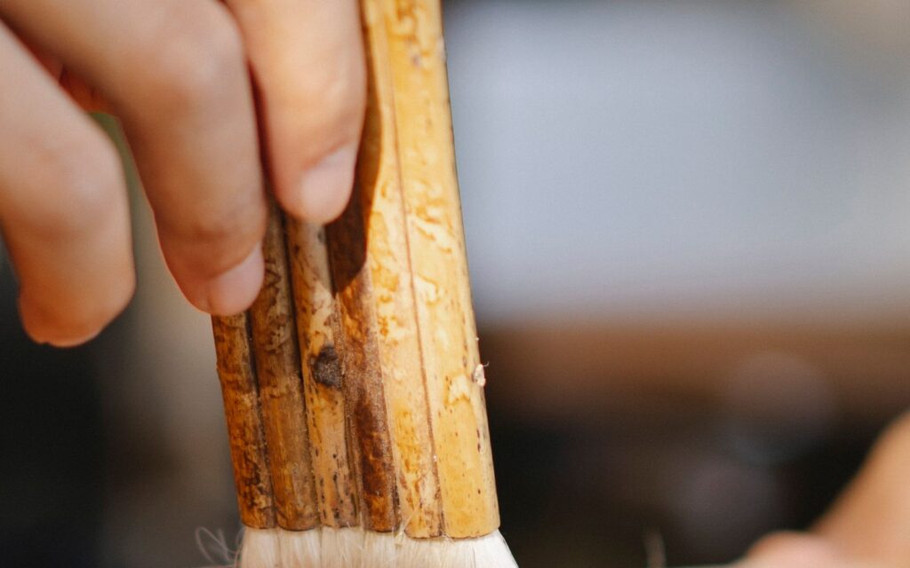 Applying a protective finish to timber with a brush