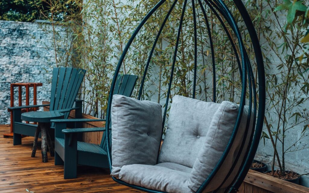 Cosy outdoor seating with cushions and a hanging chair