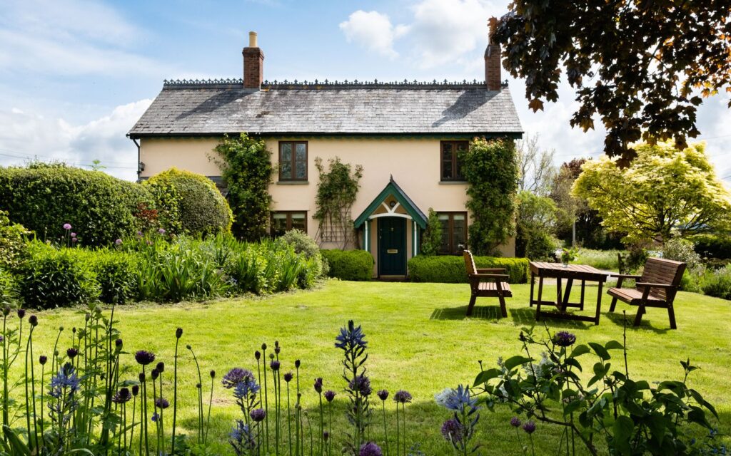 Cottage garden with a seating area among flowers