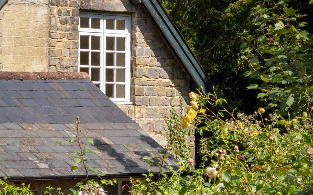 English cottage surrounded by a rose garden