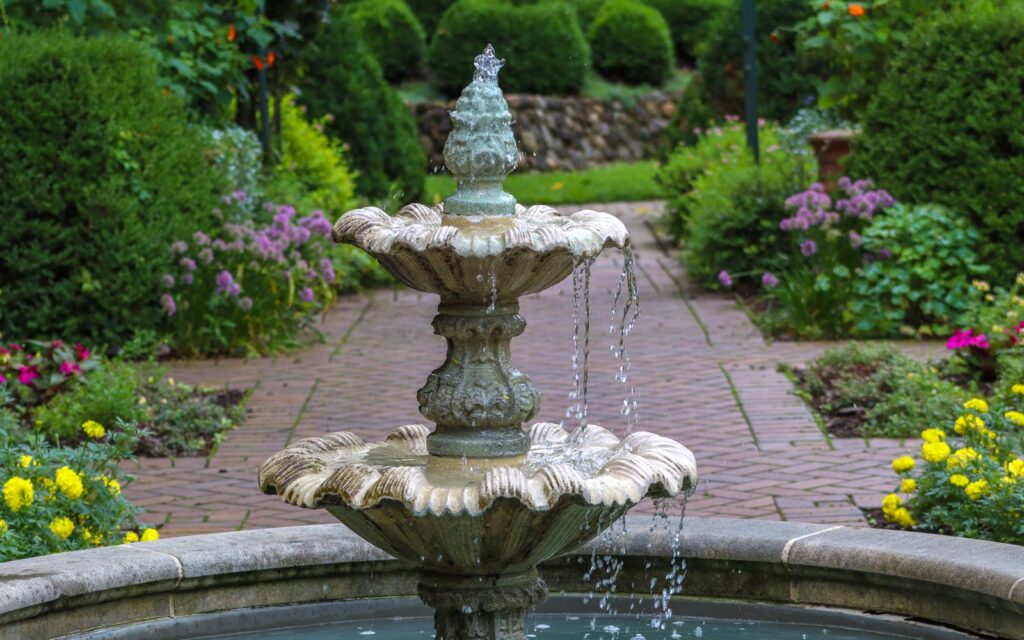 Stone fountain in a flowering garden