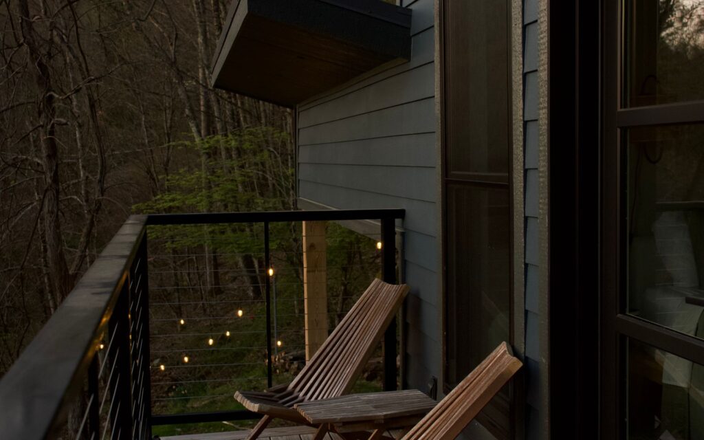 Wooden deck with chairs overlooking trees