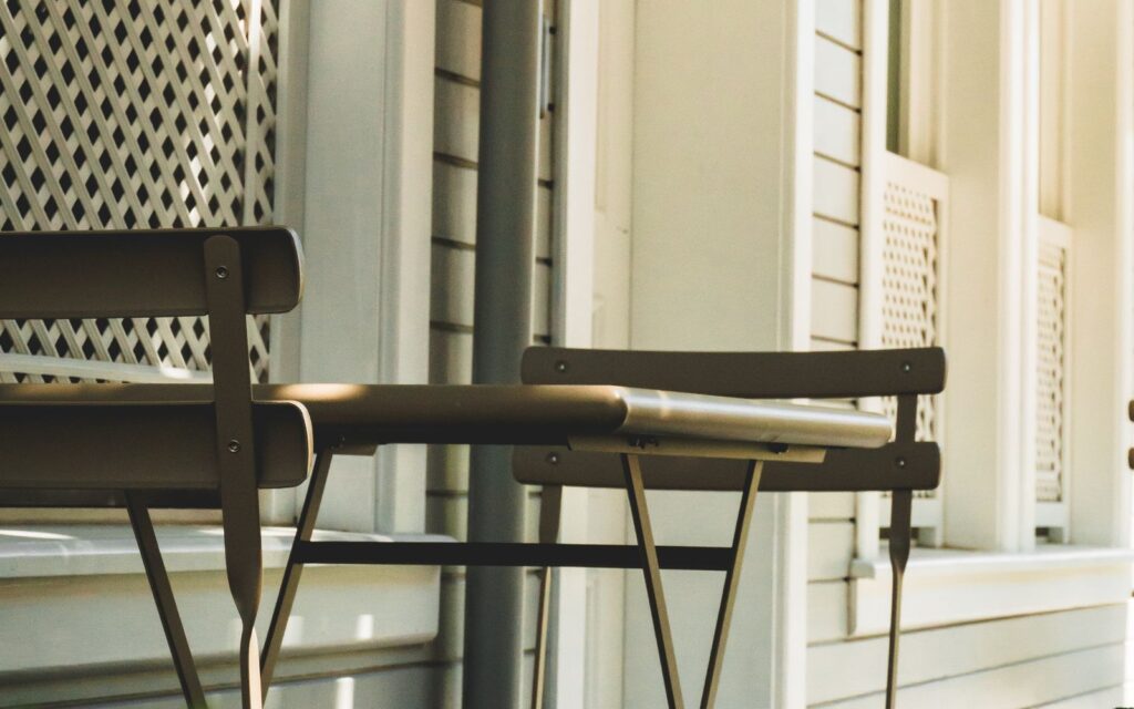 Vintage metal bistro set beside a house