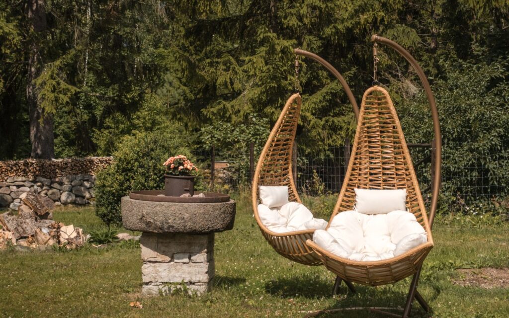 Hanging wicker chairs in a garden