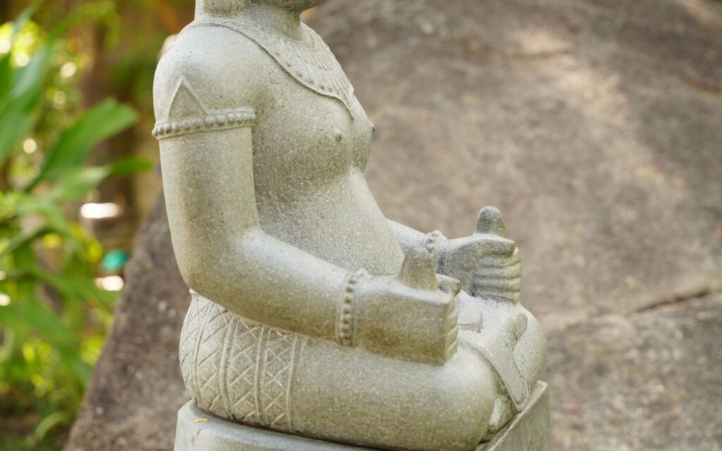 Stone sculpture in a planted garden