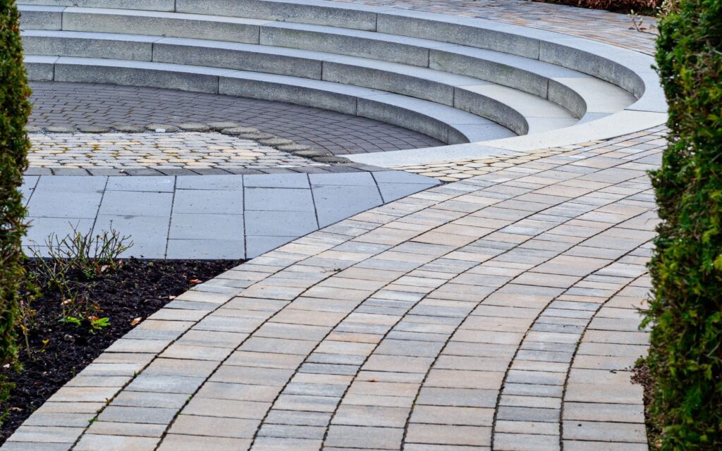 Curved brick path leading to a sunken seating area