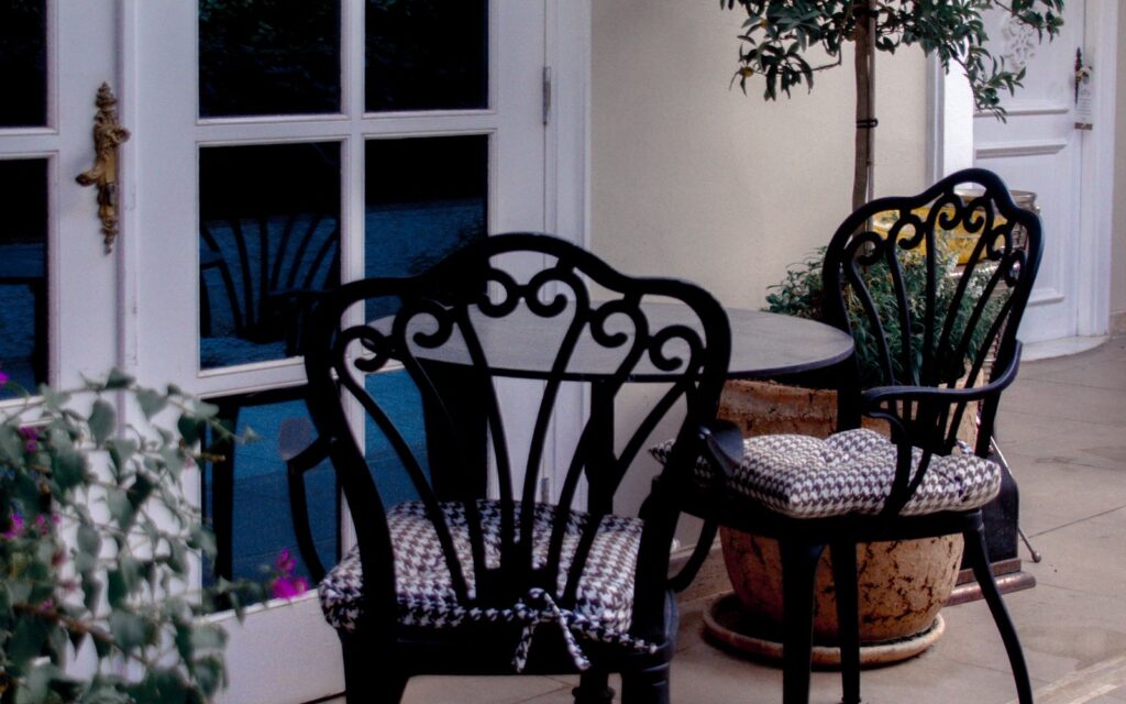 Small patio with vintage wrought iron chairs