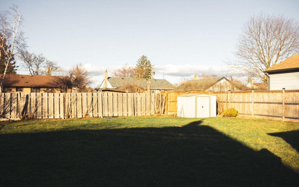 Tidy backyard with lawn, fence and shed