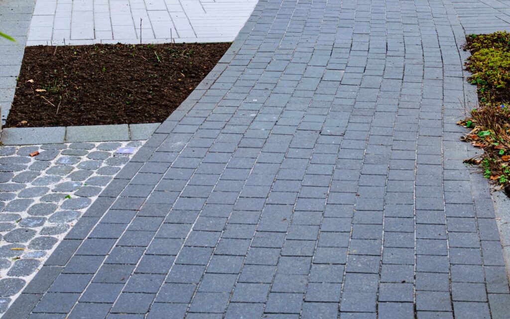 Curved brick path in a small urban garden