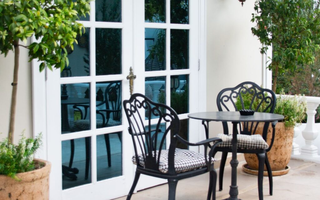 French doors opening onto a patio with seating