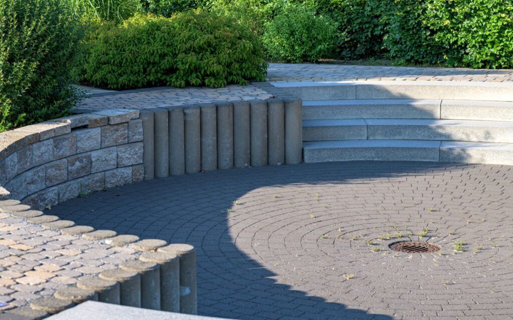 Garden with a stone patio, steps and different levels