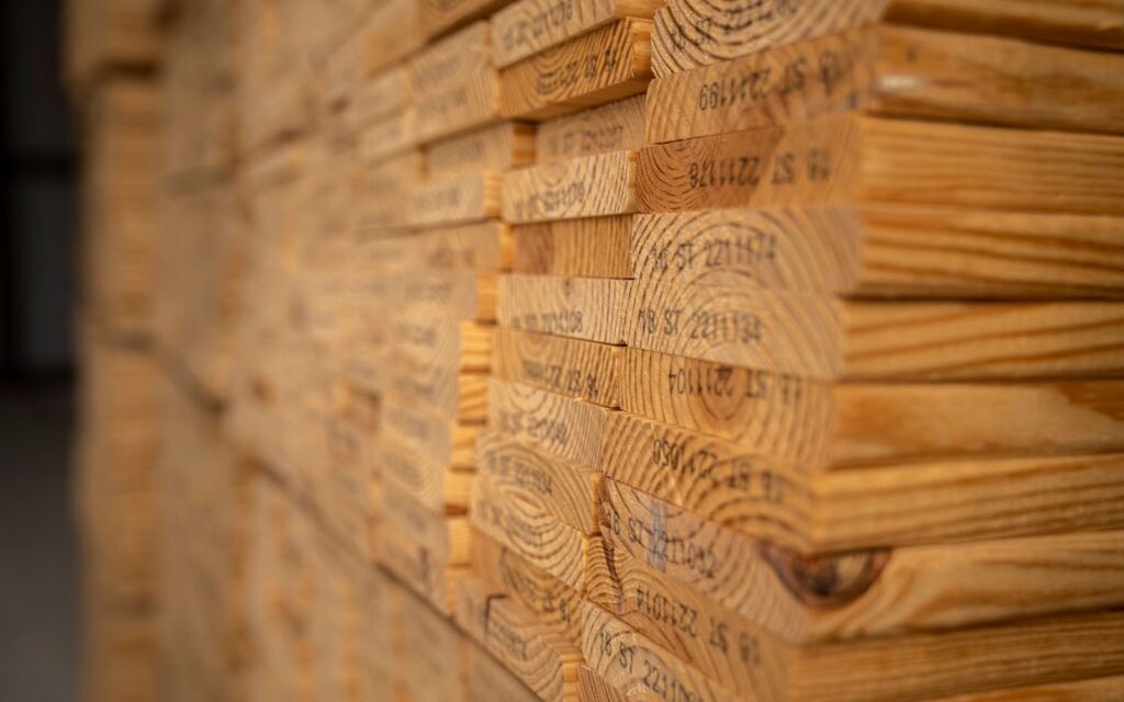 Neatly stacked timber ready for a building kit
