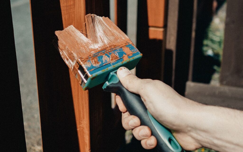 Brushing protective finish onto outdoor timber