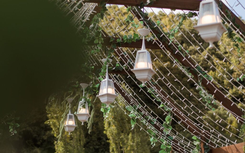 Lights and lanterns hanging from a pergola